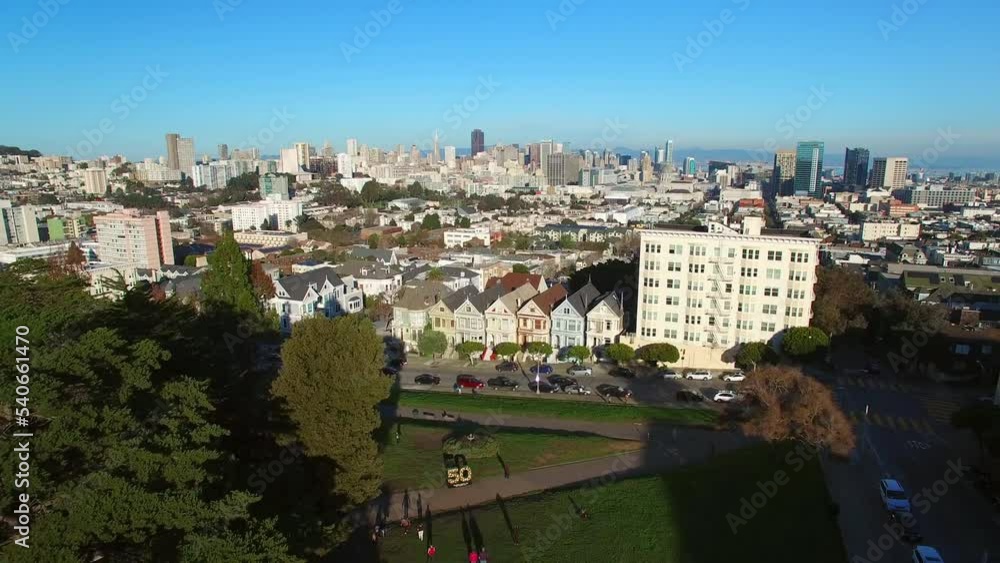 Aerial Shot Of Residential Houses And Buildings In City, Drone Flying Backwards Over People In Park - San Francisco, California Aerial Shot Of Residential Houses And Buildings In City, Drone Flying Backwards Over People In Park - San Francisco, California