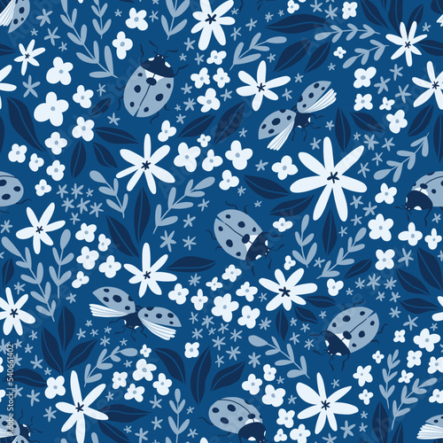 Vector insect seamless pattern. Hand-drawn ladybugs and flowers on the blue background. Summer ditzy floral pattern. photo