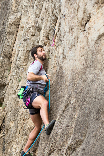 person climbing on a rock
