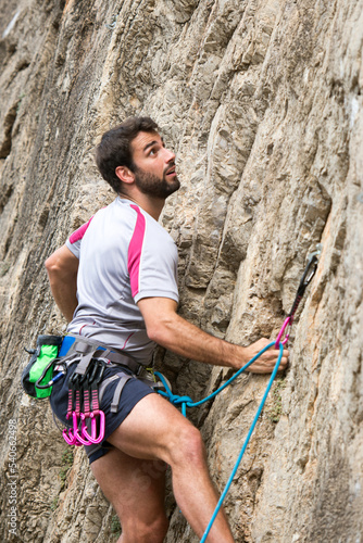 person climbing on the rock