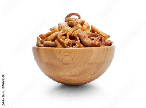 A snack bowl of salted savoury party food, crispy nibbles isolated against a transparent background viewed from the side.