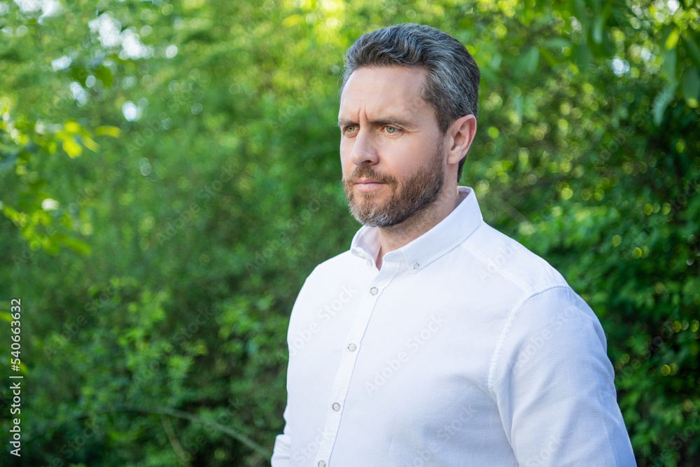 Handsome professional man in white shirt natural background, copy space Handsome professional man in white shirt natural background, copy space