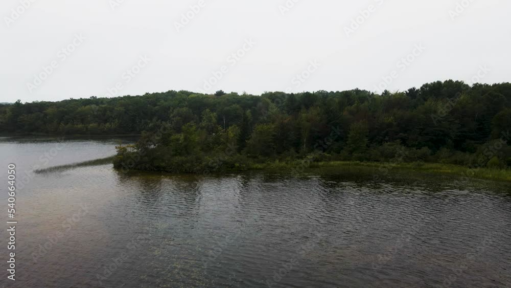 Still take as breeze lightly caresses the trees and water on Little Black Lake before a storm. Still take as breeze lightly caresses the trees and water on Little Black Lake before a storm.