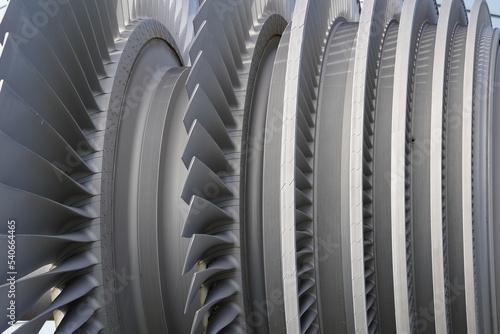 Close view on low-pressure turbine rotor with shrouded and standing blades used in nuclear power plant. Blades are produced from  special alloy.