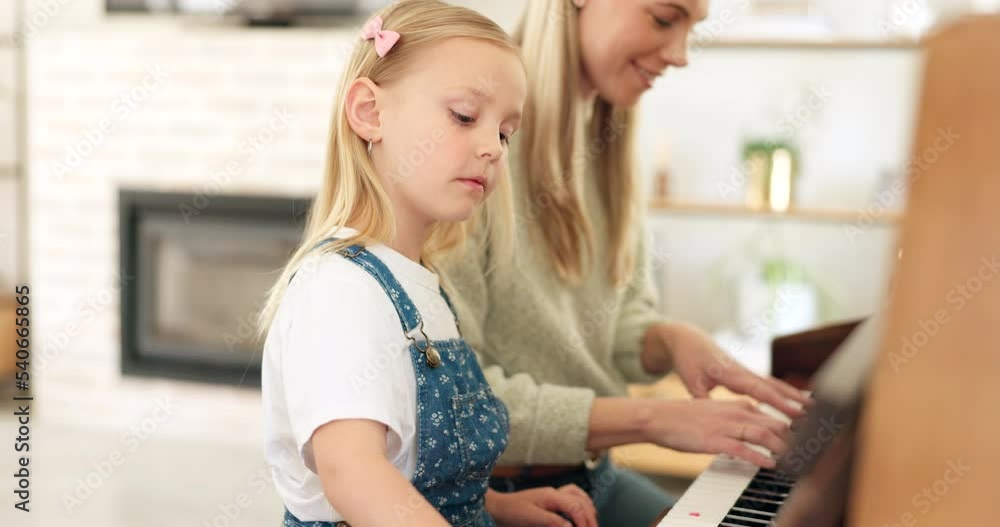 Music development, girl learning piano and musical note education from mom in the home living room. A child musician playing keys, learn creative audio art and fun concert performance in family house Music development, girl learning piano and musical note education from mom in the home living room. A child musician playing keys, learn creative audio art and fun concert performance in family house