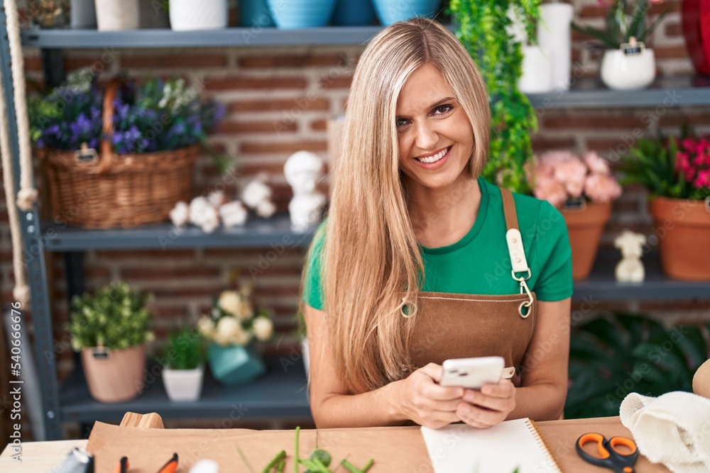 Young blonde woman florist smiling confident using smartphone at flower shop Young blonde woman florist smiling confident using smartphone at flower shop