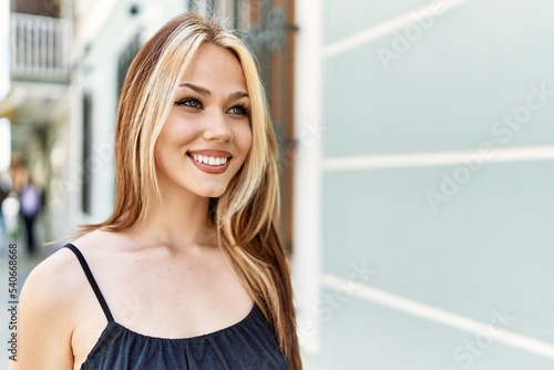 Young caucasian girl smiling happy standing at the city.