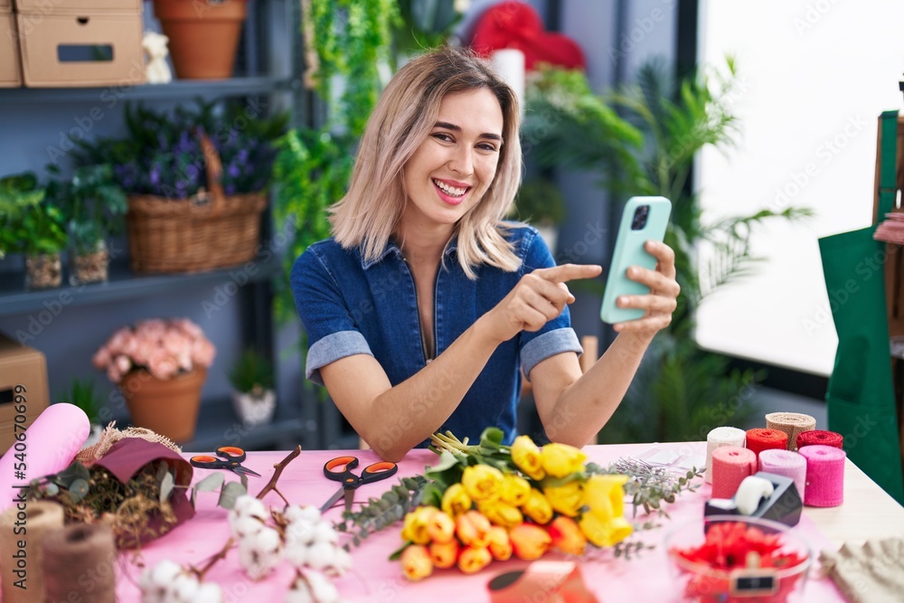 Young woman florist smiling confident using smartphone at florist Young woman florist smiling confident using smartphone at florist