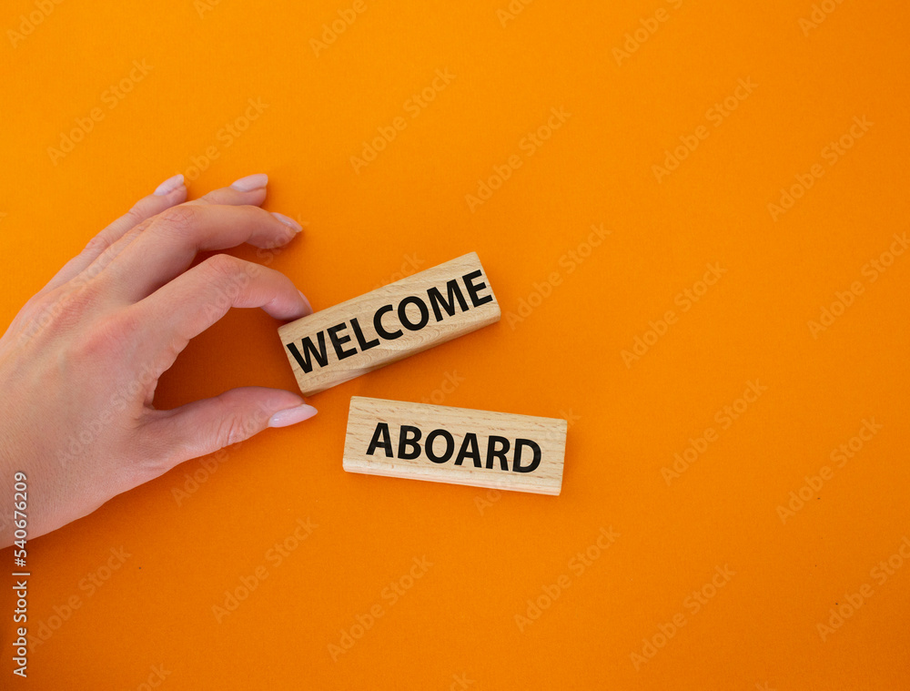 aboard symbol. Concept word aboard on wooden blocks. Beautiful orange background