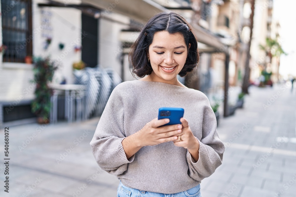 Young woman smiling confident using smartphone at street Young woman smiling confident using smartphone at street