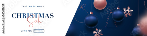 Christmas Sale header banner. Luxurious design of hanging blue and rose gold Christmas balls and snowflakes. Xmas balls motion blur effect.