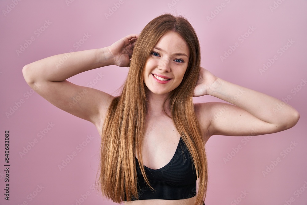 Young caucasian woman wearing lingerie over pink background smiling with a happy and cool smile on face. showing teeth. Young caucasian woman wearing lingerie over pink background smiling with a happy and cool smile on face. showing teeth.