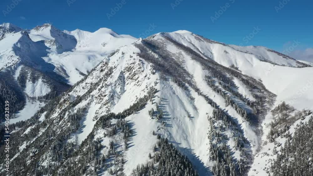 Air flight through mountain clouds over beautiful snow-capped peaks of mountains and glaciers. Air flight through mountain clouds over beautiful snow-capped peaks of mountains and glaciers.