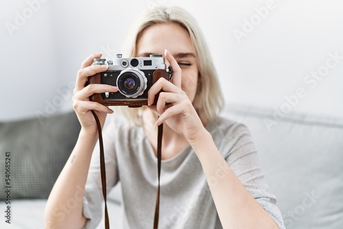 Young caucasian woman smiling confident using camera at home