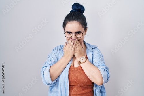 Schilderij op canvas Young modern girl with blue hair standing over white background laughing and emb