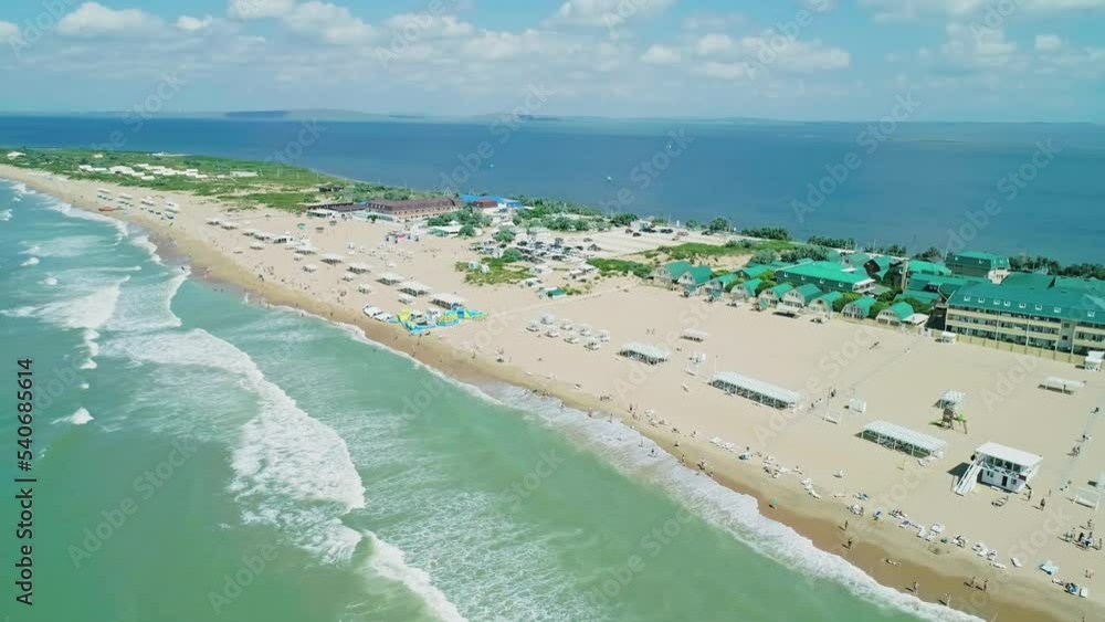 Aerial over the long sandy spit with a beach and azure water on a sunny summer day. Waves crashing to the shore. Relaxing calm atmosphere Aerial over the long sandy spit with a beach and azure water on a sunny summer day. Waves crashing to the shore. Relaxing calm atmosphere