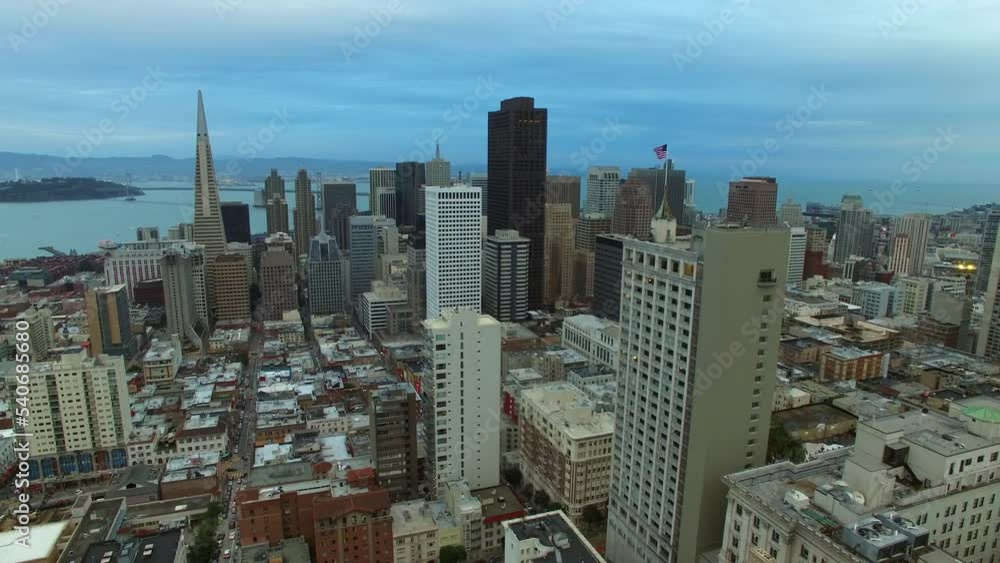 Aerial Backward Shot Of Modern Buildings By Golden Bridge In City Under Cloudy Sky - San Francisco, California Aerial Backward Shot Of Modern Buildings By Golden Bridge In City Under Cloudy Sky - San Francisco, California