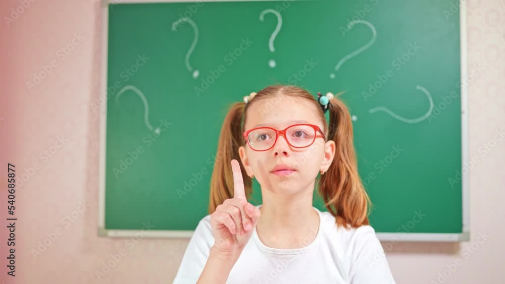 Concentrated girl in glasses thinks while a new idea pops up in her head Concentrated girl in glasses thinks while a new idea pops up in her head