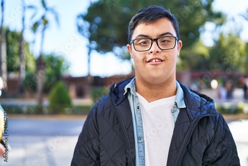 Down syndrome man smiling confident standing at park © Krakenimages.com