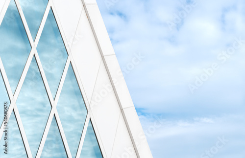 Reflection of cloud and sky on glass window of modern architecture. Building abstract background