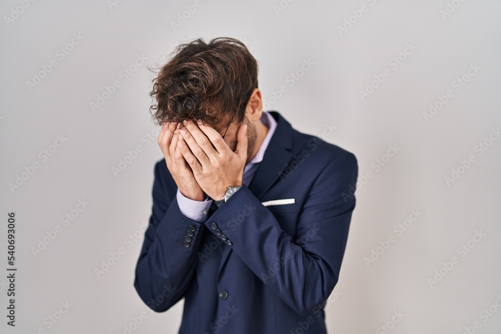 Hispanic business man wearing glasses with sad expression covering face with hands while crying. depression concept. Hispanic business man wearing glasses with sad expression covering face with hands while crying. depression concept.