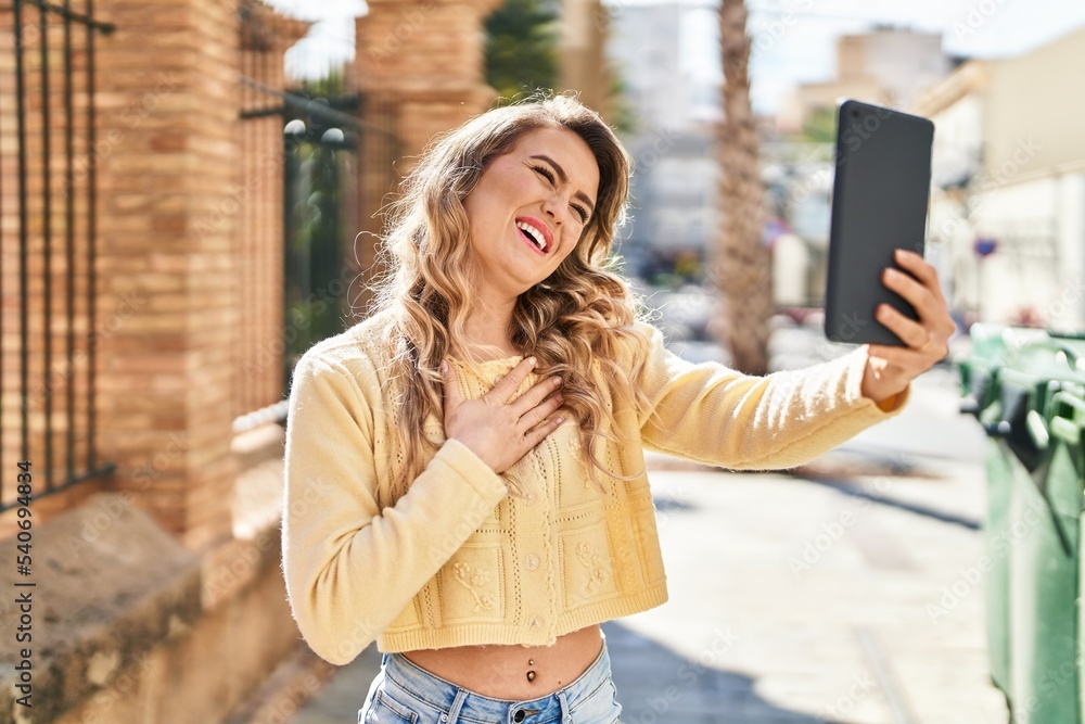 Young woman smiling confident having video call at street