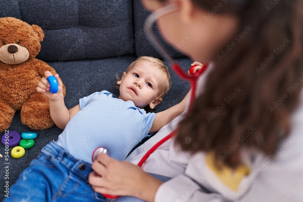 Mother and son doctor examining child at home Mother and son doctor examining child at home