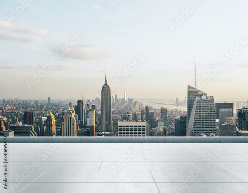 Empty concrete rooftop on the background of a beautiful New York city skyline at sunset, mock up
