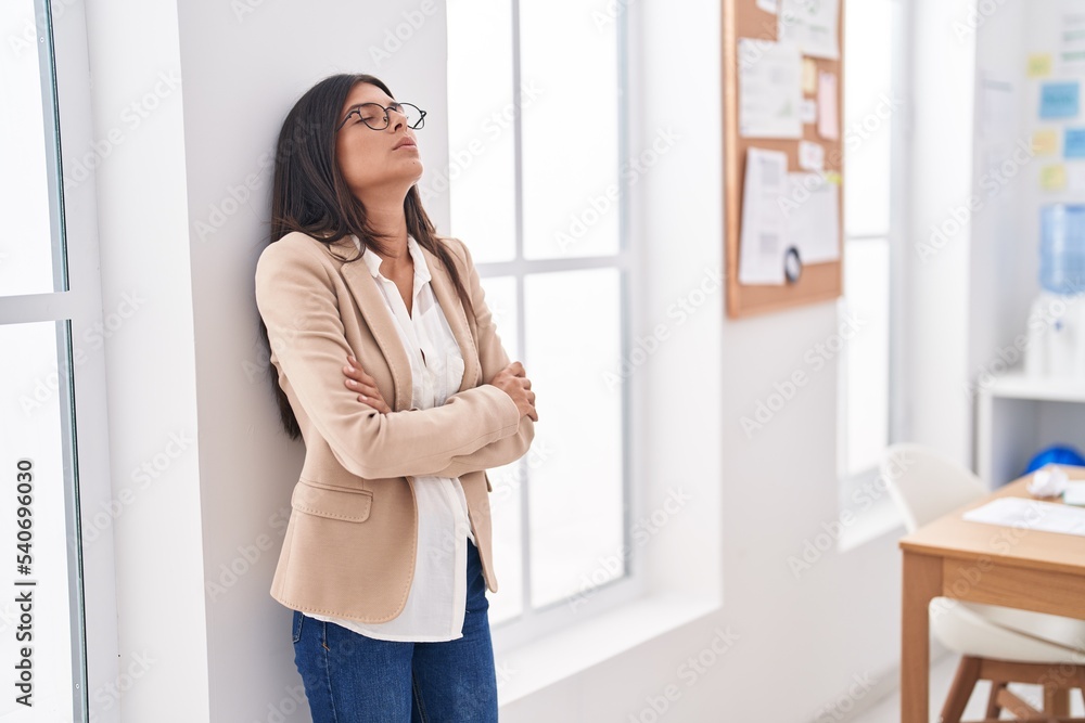 Young beautiful hispanic woman business worker standing with arms crossed gesture at office Young beautiful hispanic woman business worker standing with arms crossed gesture at office