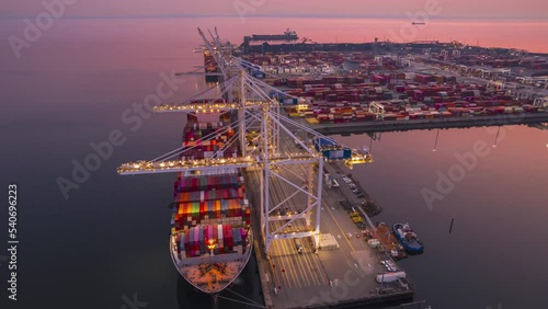 Cargo terminal loading shipping containers onto cargo ships, aerial footage, hyperlapse, Vancouver, BC, Canada, marine terminal, cargo crane. 4K 24FPS.