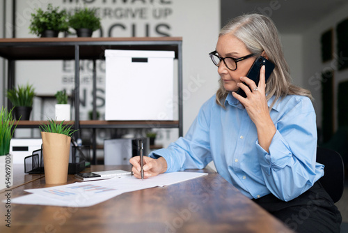 adult business woman working in office talking on mobile phone. Business Invoice Tax Management concept