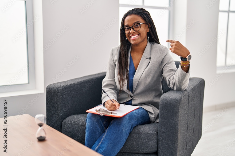 Young african american with braids working at consultation office looking confident with smile on face, pointing oneself with fingers proud and happy. Young african american with braids working at consultation office looking confident with smile on face, pointing oneself with fingers proud and happy.