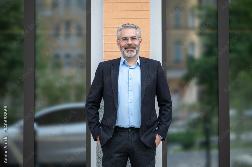 Gray-haired man in a suit looking determined Gray-haired man in a suit looking determined