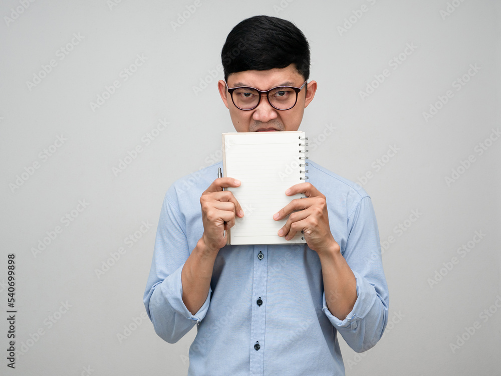 Young manager man holding the book close his face looking at you isolated Young manager man holding the book close his face looking at you isolated