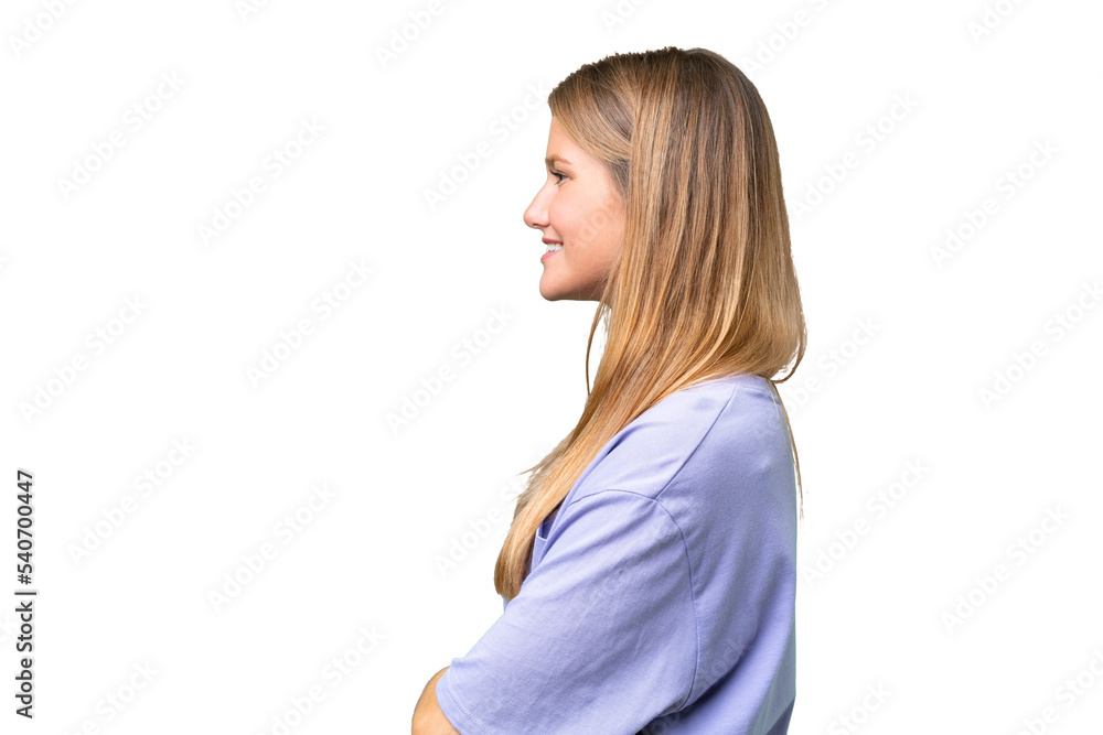 Young beautiful woman over isolated background in lateral position Young beautiful woman over isolated background in lateral position