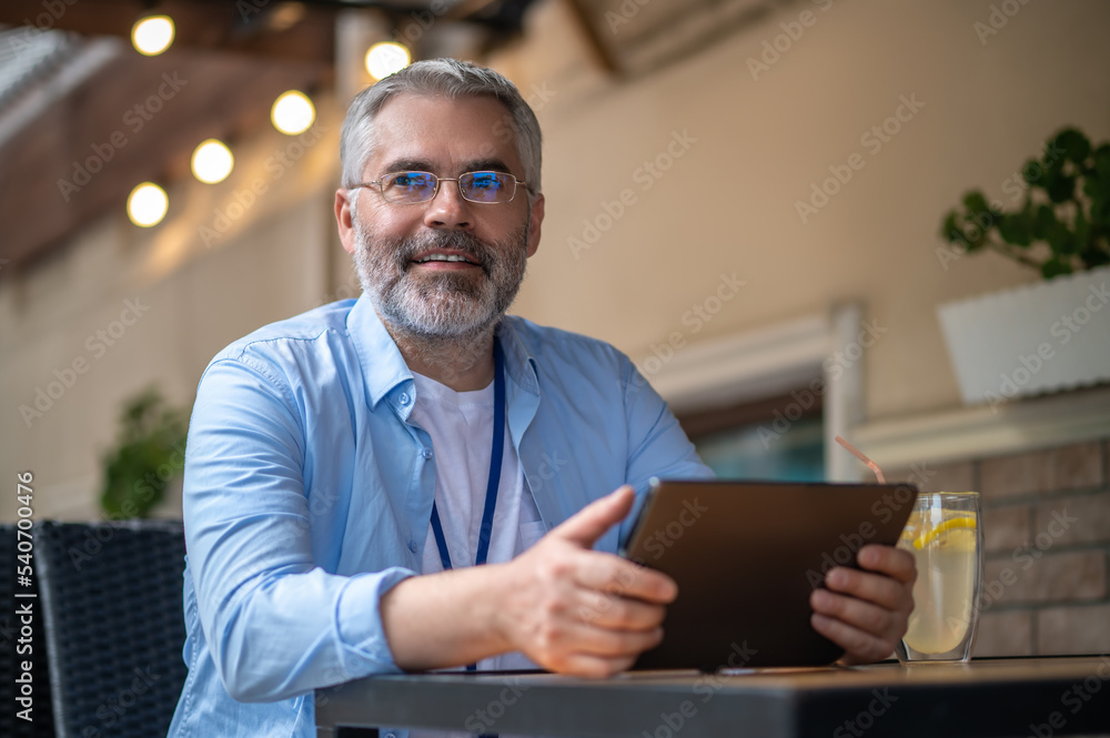Gray-haired mid aged man with a laptop Gray-haired mid aged man with a laptop