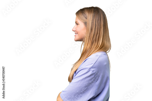 Young beautiful woman over isolated background in lateral position