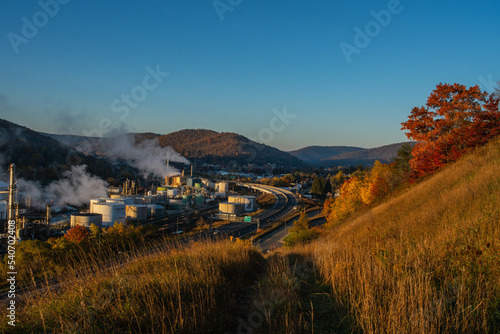 autumn in the mountains with a power plant in the valley town 