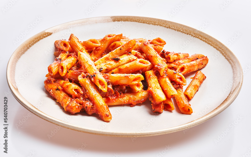 Delicious plate of italian macaroni with tomato sauce over isolated white background Delicious plate of italian macaroni with tomato sauce over isolated white background