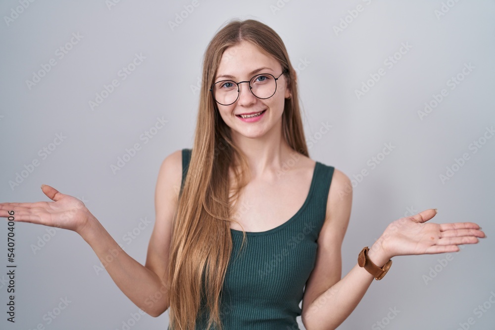 Young caucasian woman standing over white background smiling cheerful offering hands giving assistance and acceptance. Young caucasian woman standing over white background smiling cheerful offering hands giving assistance and acceptance.