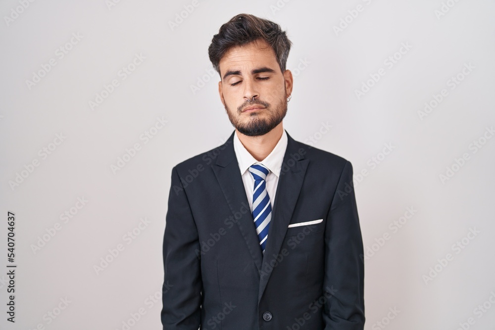 Young hispanic man with tattoos wearing business suit and tie looking sleepy and tired, exhausted for fatigue and hangover, lazy eyes in the morning. Young hispanic man with tattoos wearing business suit and tie looking sleepy and tired, exhausted for fatigue and hangover, lazy eyes in the morning.