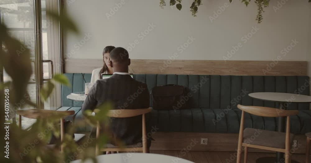 International business team working in a café bar, wide scene International business team working in a café bar, wide scene