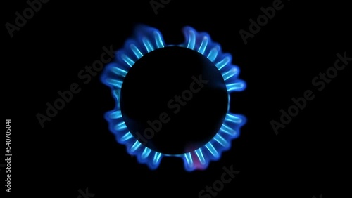 Lighting up blue gas in a gas stove top view, on a black background. Slow motion photo