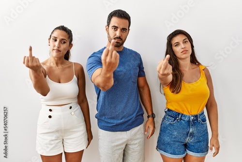 Group of young hispanic people standing over isolated background showing middle finger  impolite and rude fuck off expression