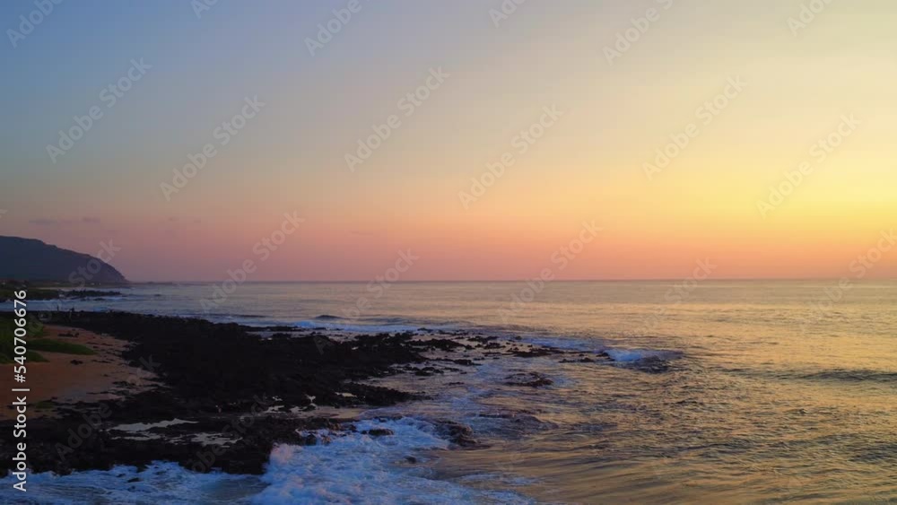 Aerial Scenic View Of Wavy Sea By Island, Drone Flying Forward At Sunset - Oahu, Hawaii Aerial Scenic View Of Wavy Sea By Island, Drone Flying Forward At Sunset - Oahu, Hawaii