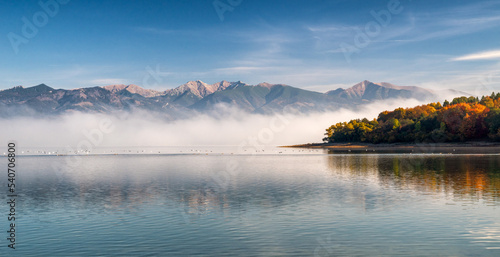 Autumn lakescape. Water reservoir Liptovska Mara and Western Tatras mountains at background