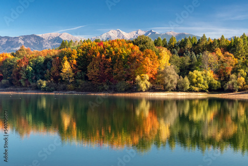 Autumn landscape with lake and mountains.