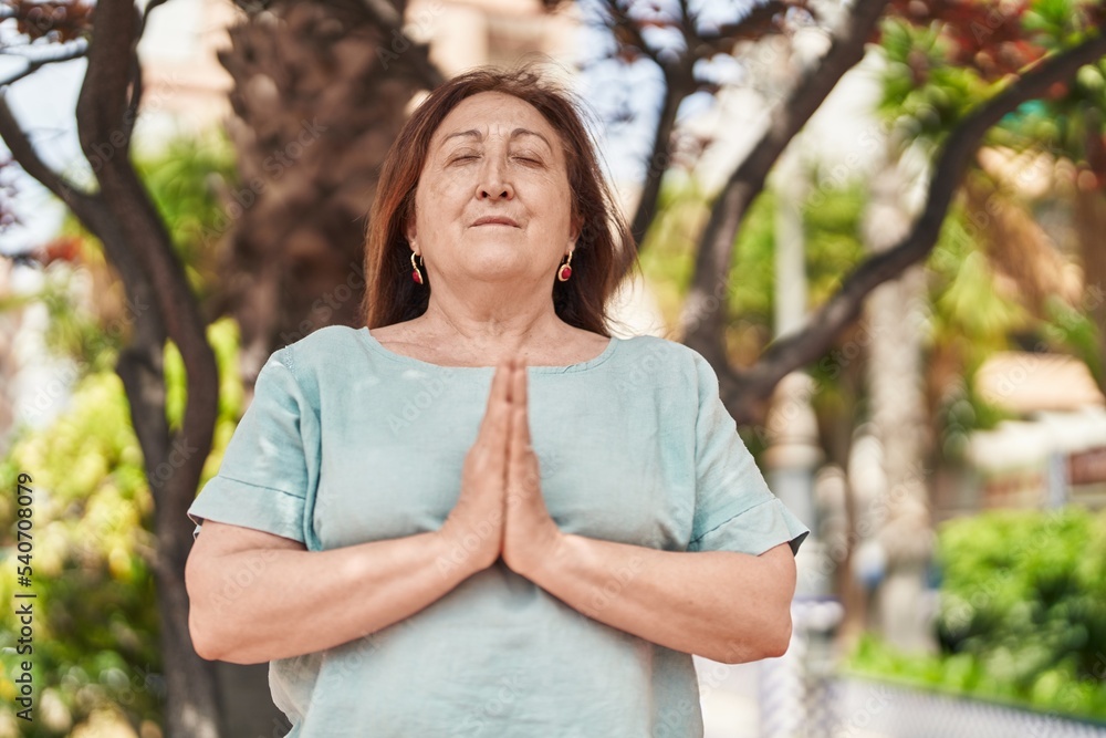 Senior woman doing yoga exercise at park Senior woman doing yoga exercise at park