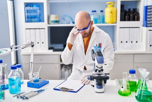 Young man scientist stressed working at laboratory