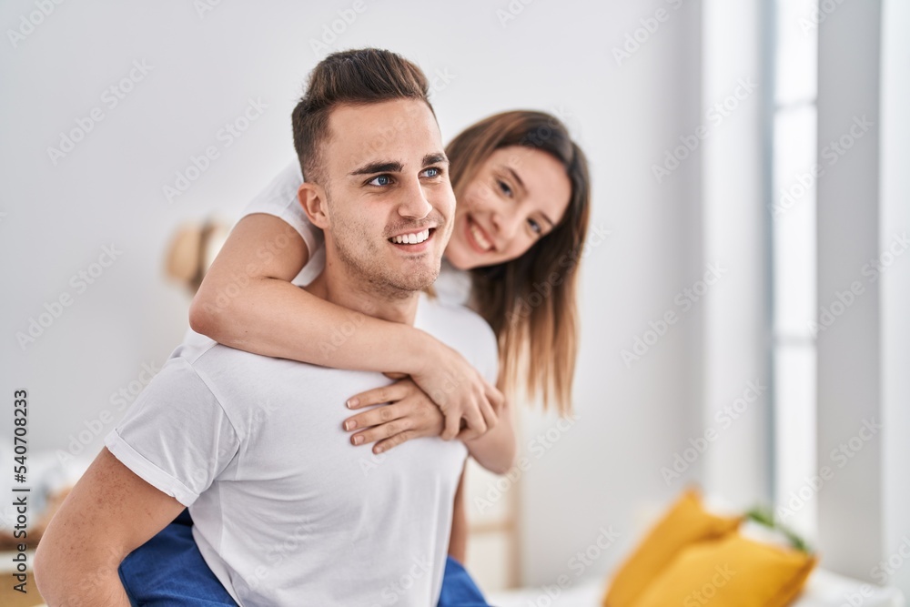 Man and woman couple holding on back standing at bedroom Man and woman couple holding on back standing at bedroom